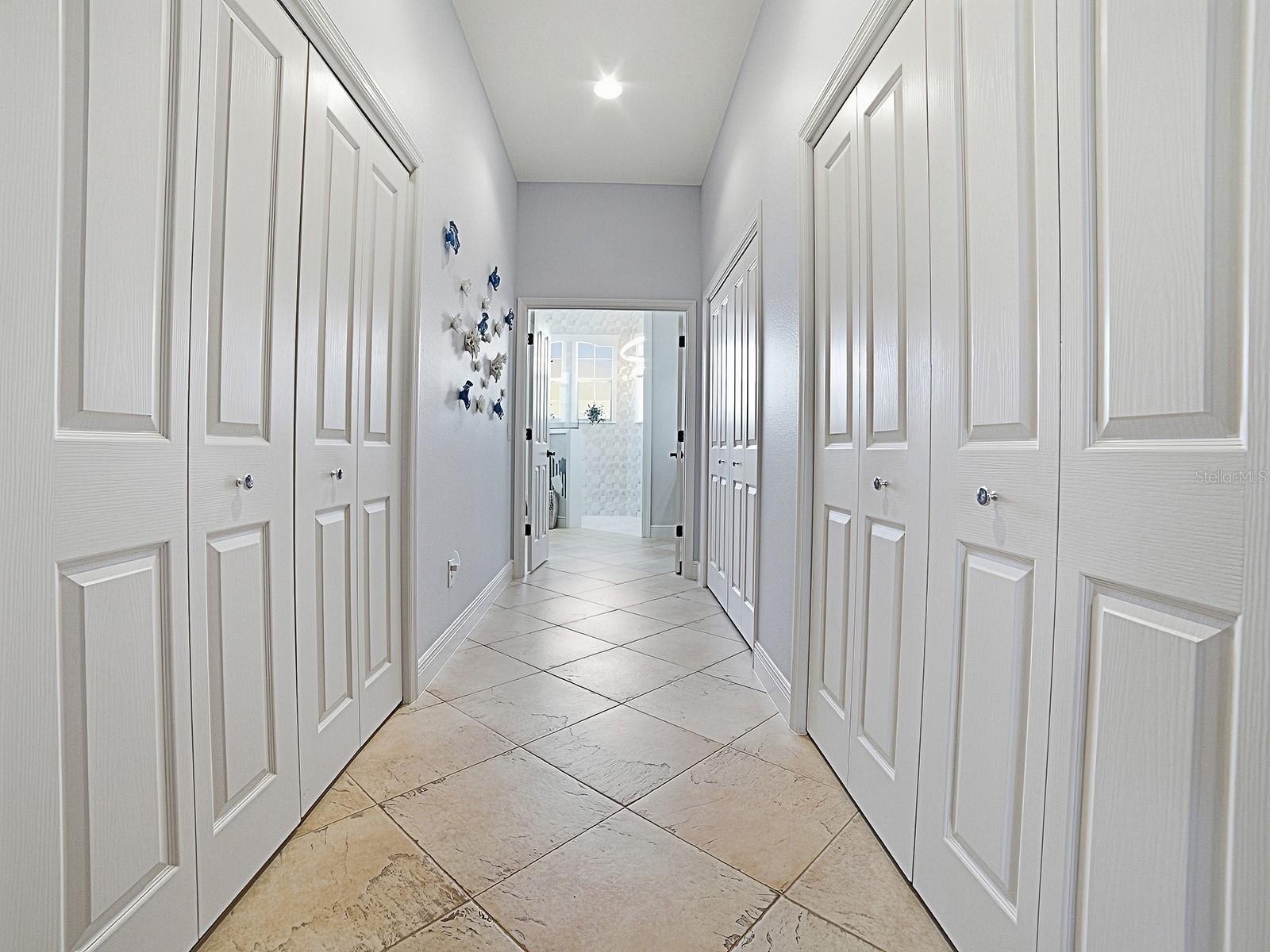 LARGE WALK-IN CLOSET ON THE LEFT WITH SOLAR TUBE, AND ON THE RIGHT MORE CLOSET SPACE. THE 2ND SET OF DOUBLE DOORS ON THE RIGHT HAS MORE STORAGE AND 2N