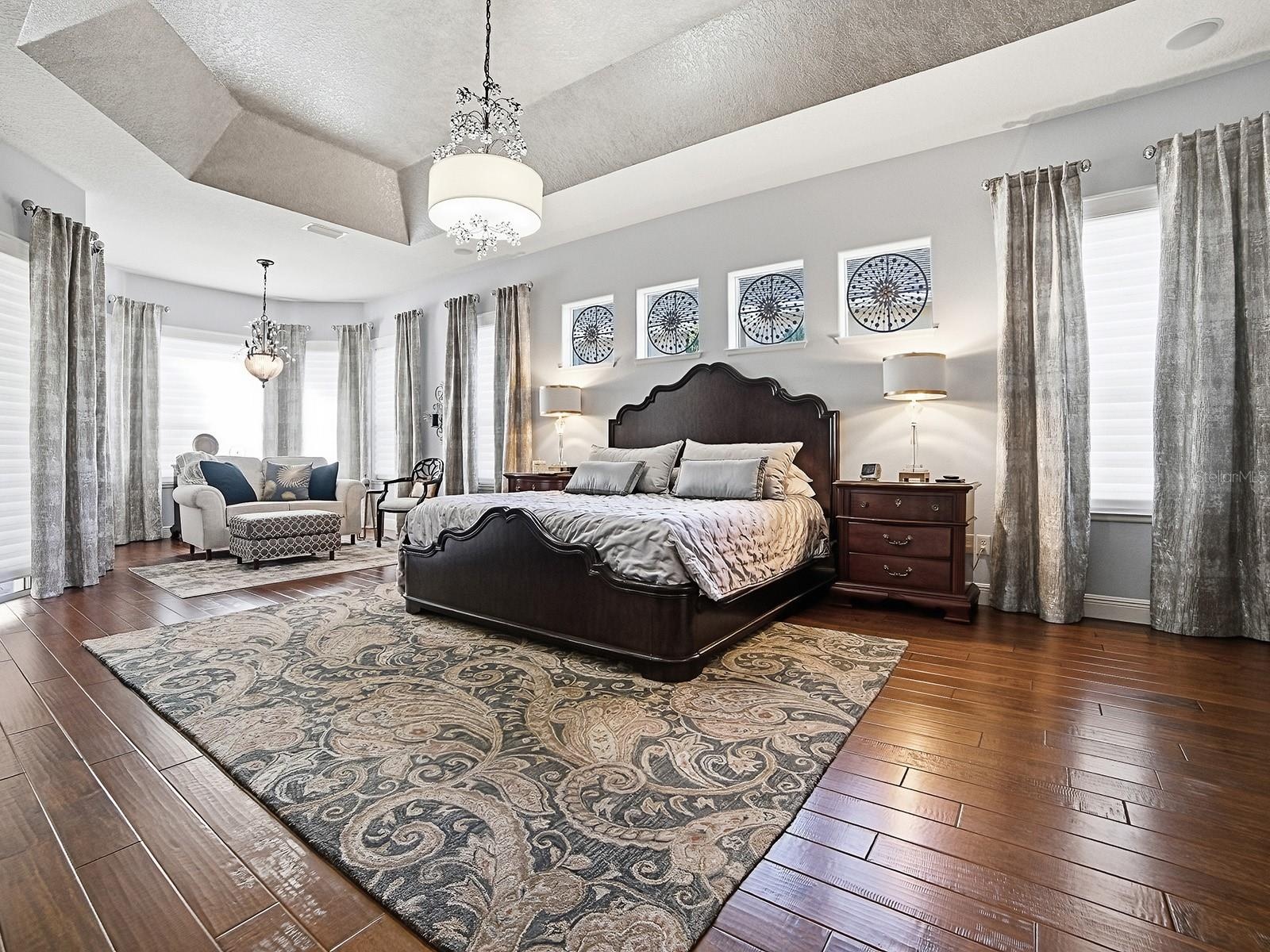 PRIMARY BEDROOM - WOW! HARDWOOD FLOORING, CUSTOM DRAPES, CUSTOM FIXTURES - A SPECTACULAR, SPACIOUS ROOM!