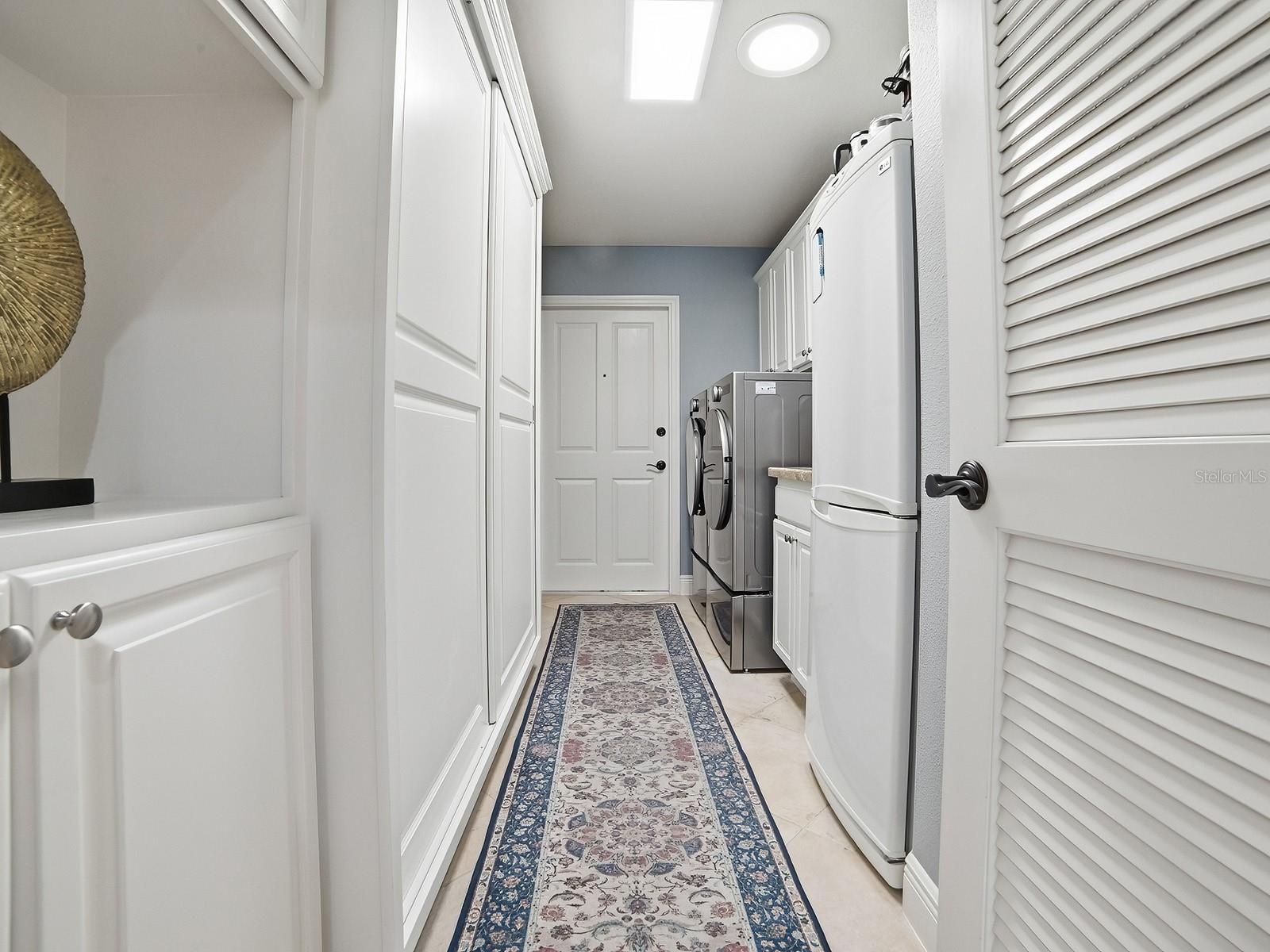 THE LAUNDRY ROOM HAS A NEW FRONT LOAD WASHER AND DRYER, A SINK, AND ALL THE CABINET SPACE YOU SEE HAS BEEN ADDED OFFERING SO MUCH EXTRA STORAGE. AN AR