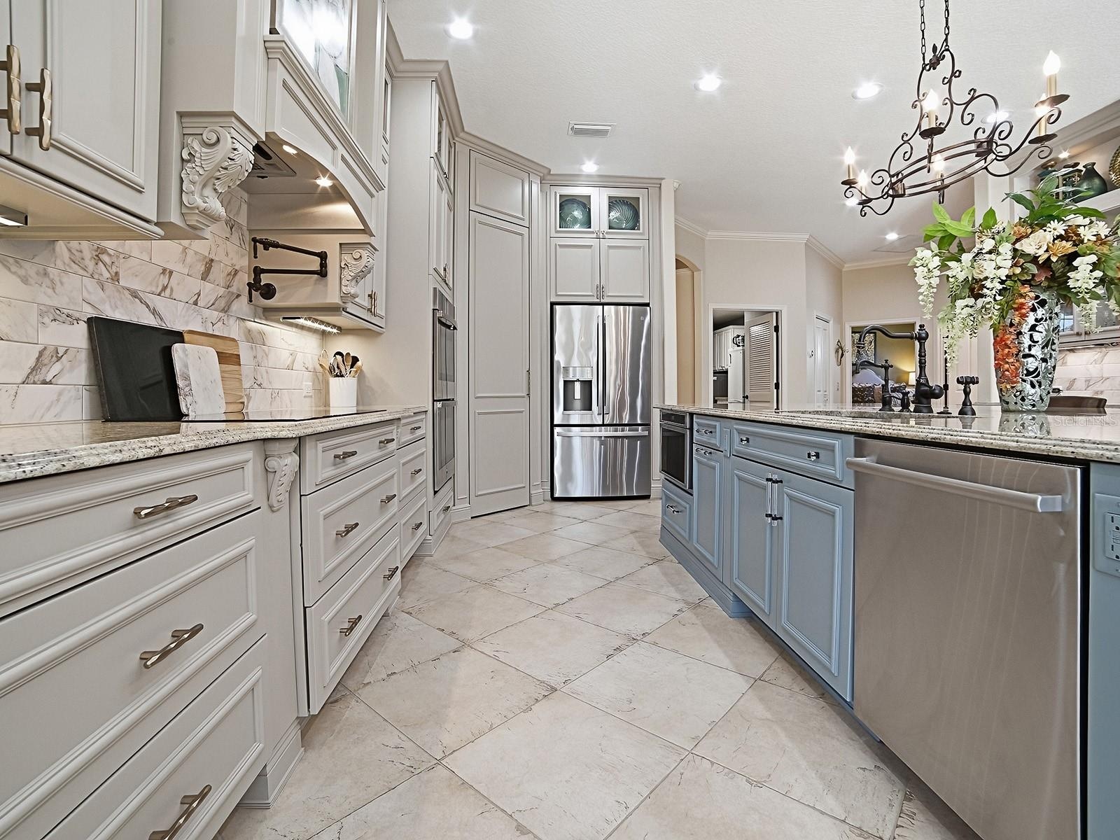 NEW CABINETRY, GRANITE COUNTERTOPS, STAINLESS APPLIANCES WITH 5 BURNER INDUCTION COOKTOP, HOOD, AND MICROWAVE DRAWER, BOSCH DISHWASHER, POT DRAWERS, L