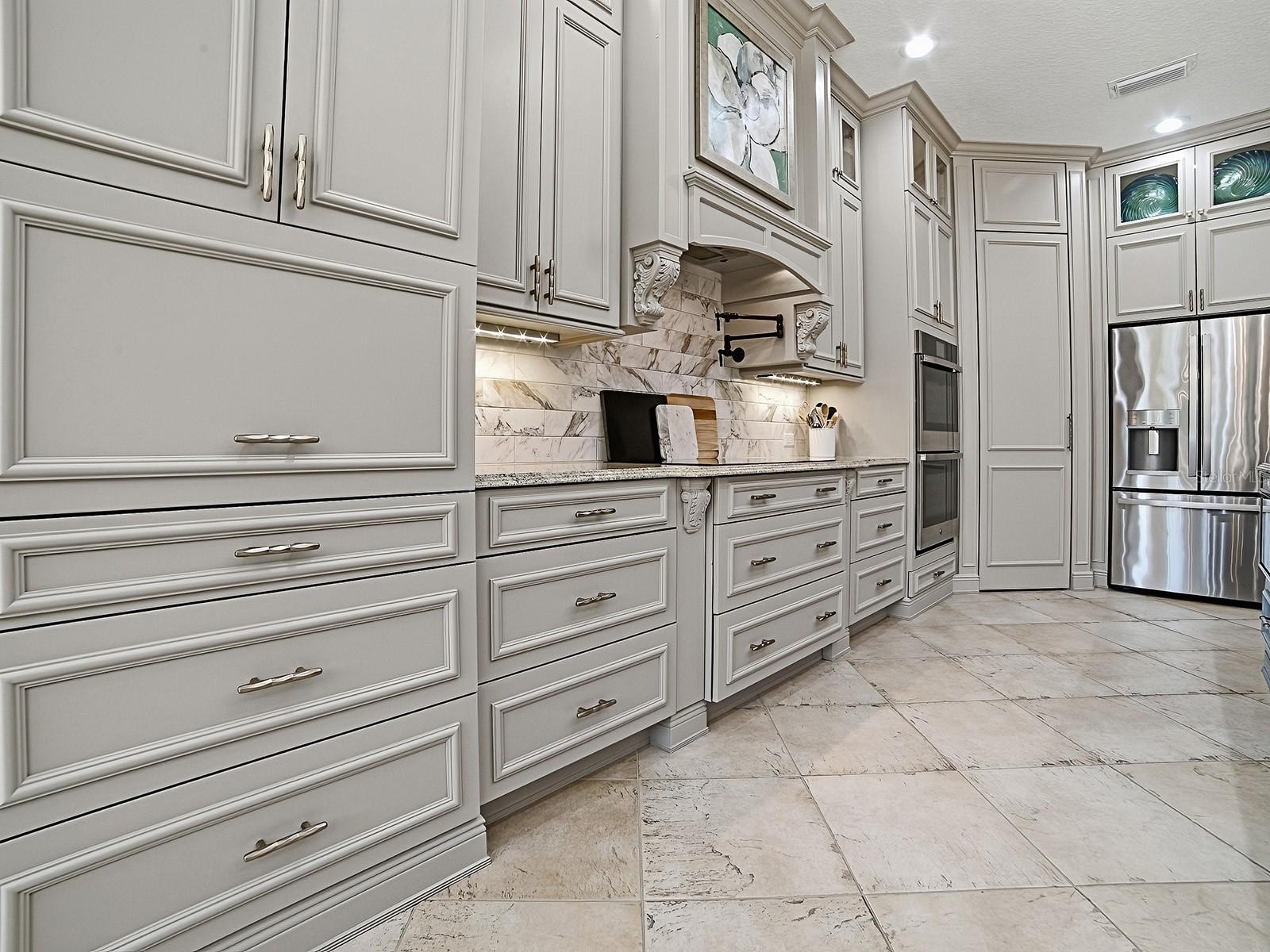 THE APPLIANCE GARAGE CLOSED IN THIS PHOTO, LOVELY TILED BACKSPLASH AND MANY LIGHTING OPTIONS.