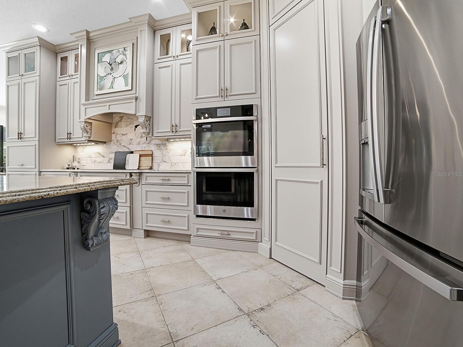 WALL OVENS AND A WALK-IN PANTRY WITH CUSTOM SHELVING AND POT FILLER!
