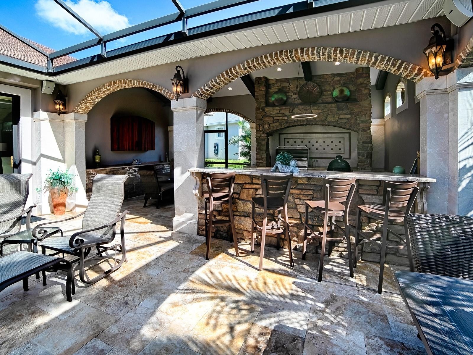 A GREAT PLACE FOR ENTERTAINING WITH THE SUMMER KITCHEN OFFERING AN ALFRESCO GRILL AND REFRIGERATOR.