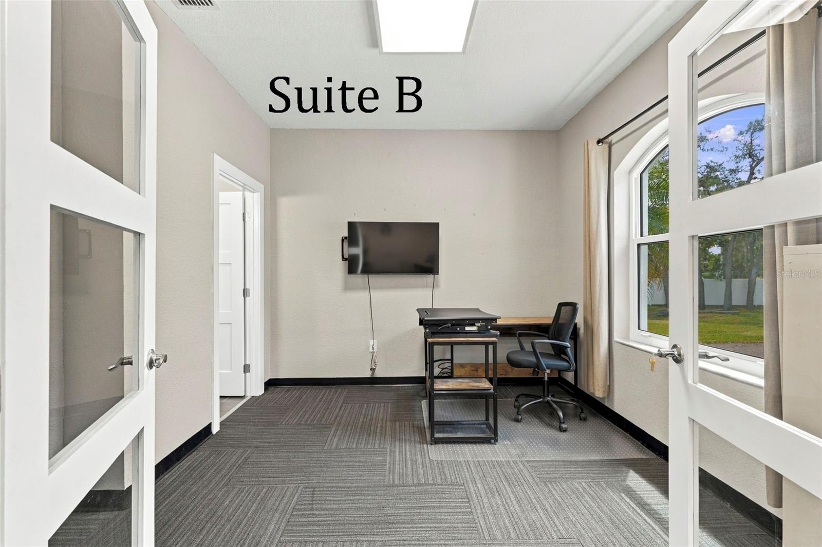 Double Glass Doors into Suite B, with Private Full Bathroom, Window to the Front of the Office, located by the Lobby