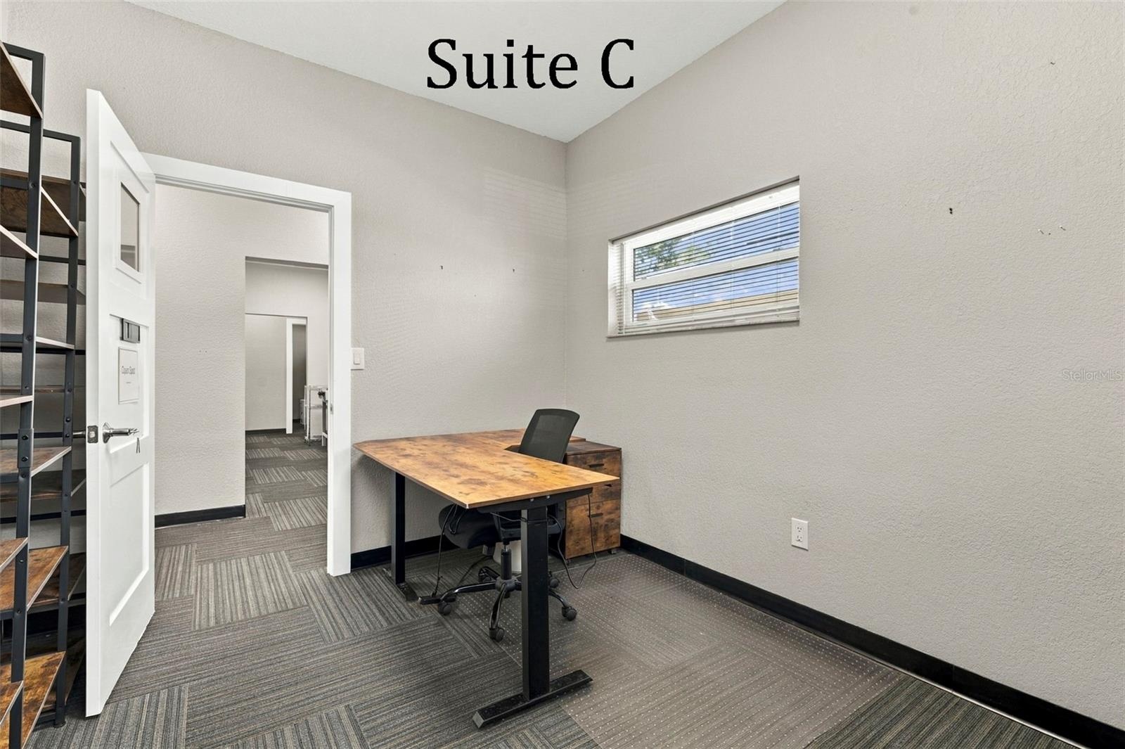 Suite C has 2 high windows and is located by the Coffee Station, Hall Restroom and Covered Patio Break Common Area