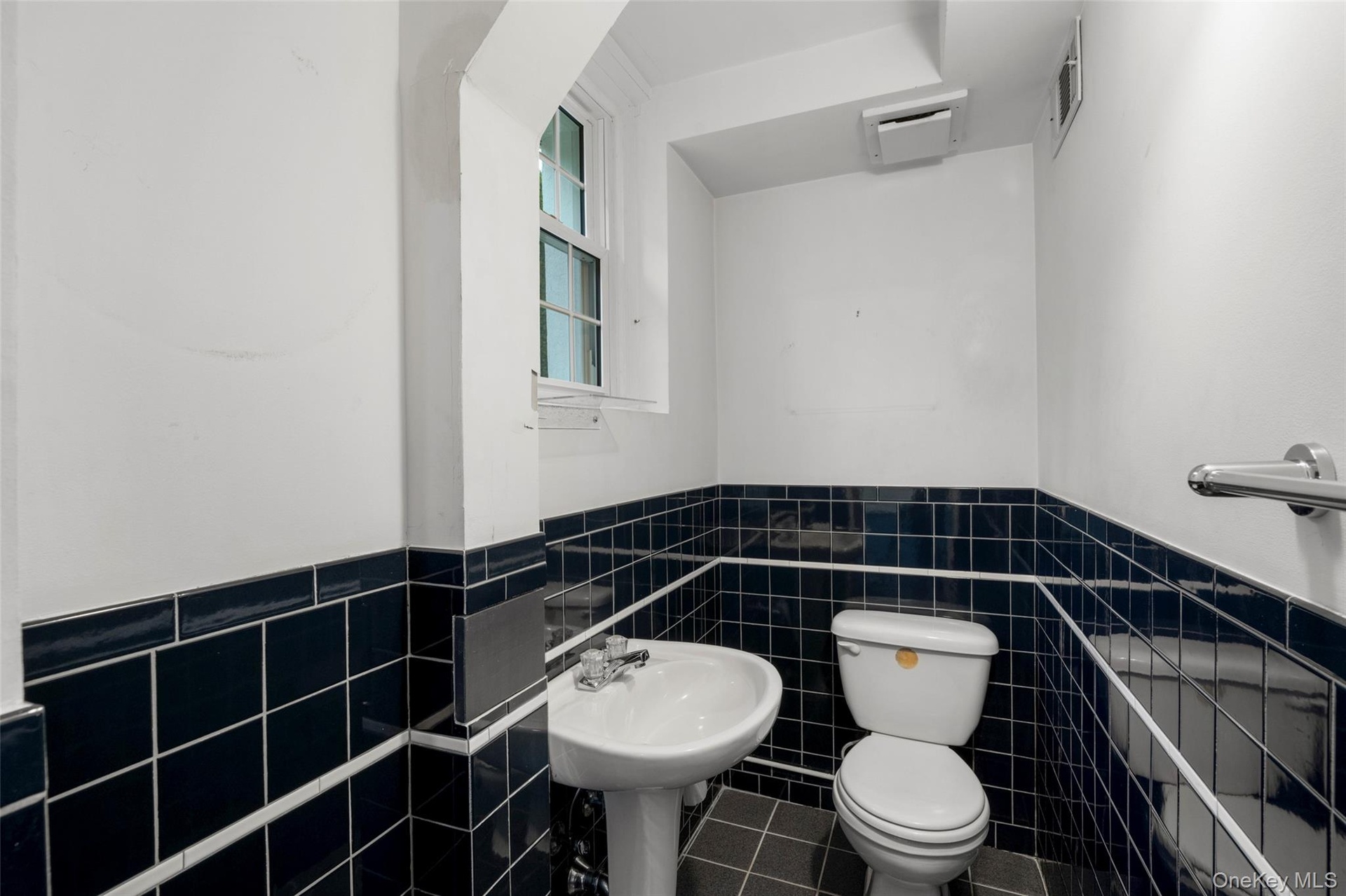 Powder room with window adjoining family room