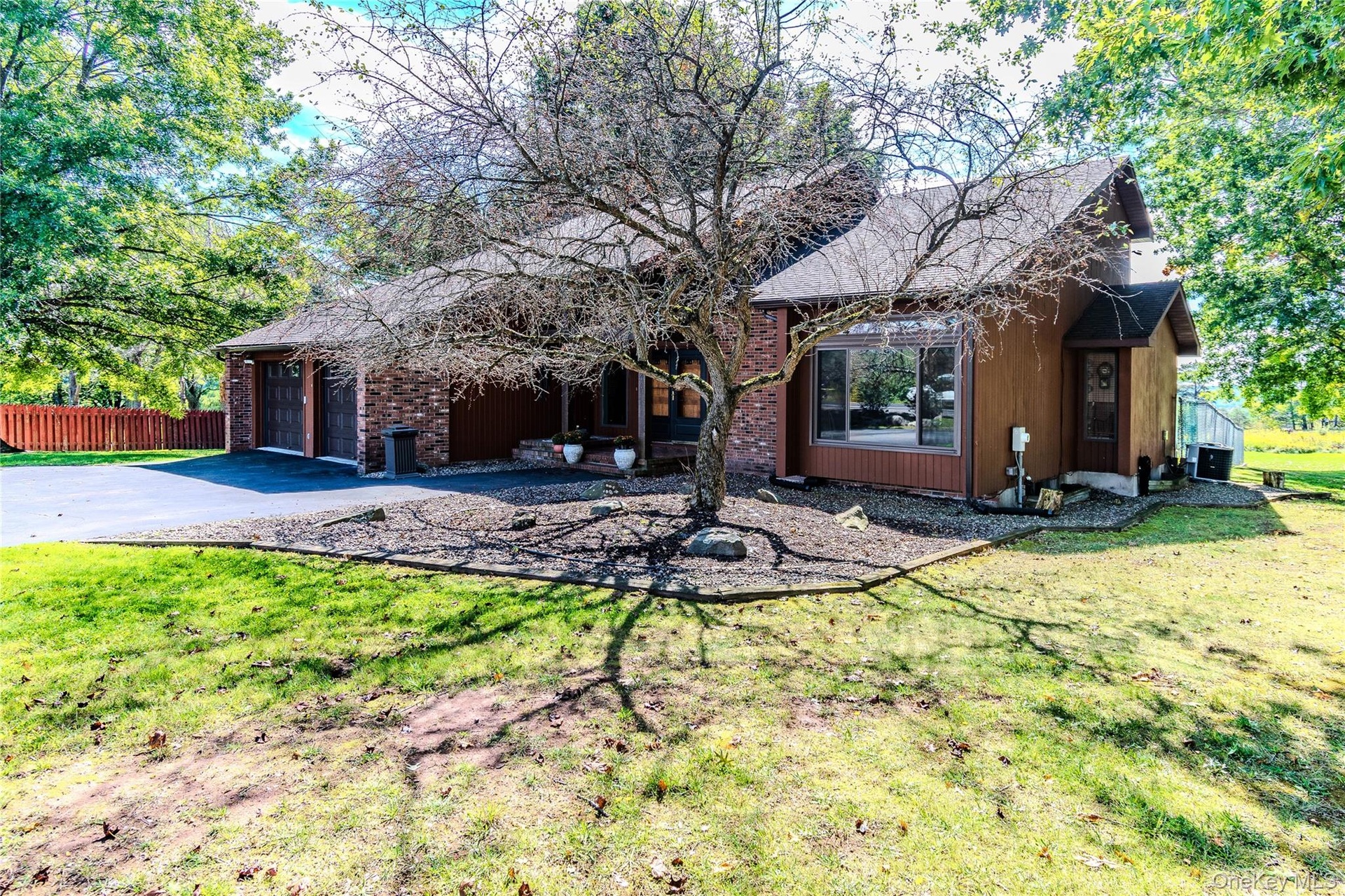 Brick and siding exterior with a dark asphalt shingle roof
