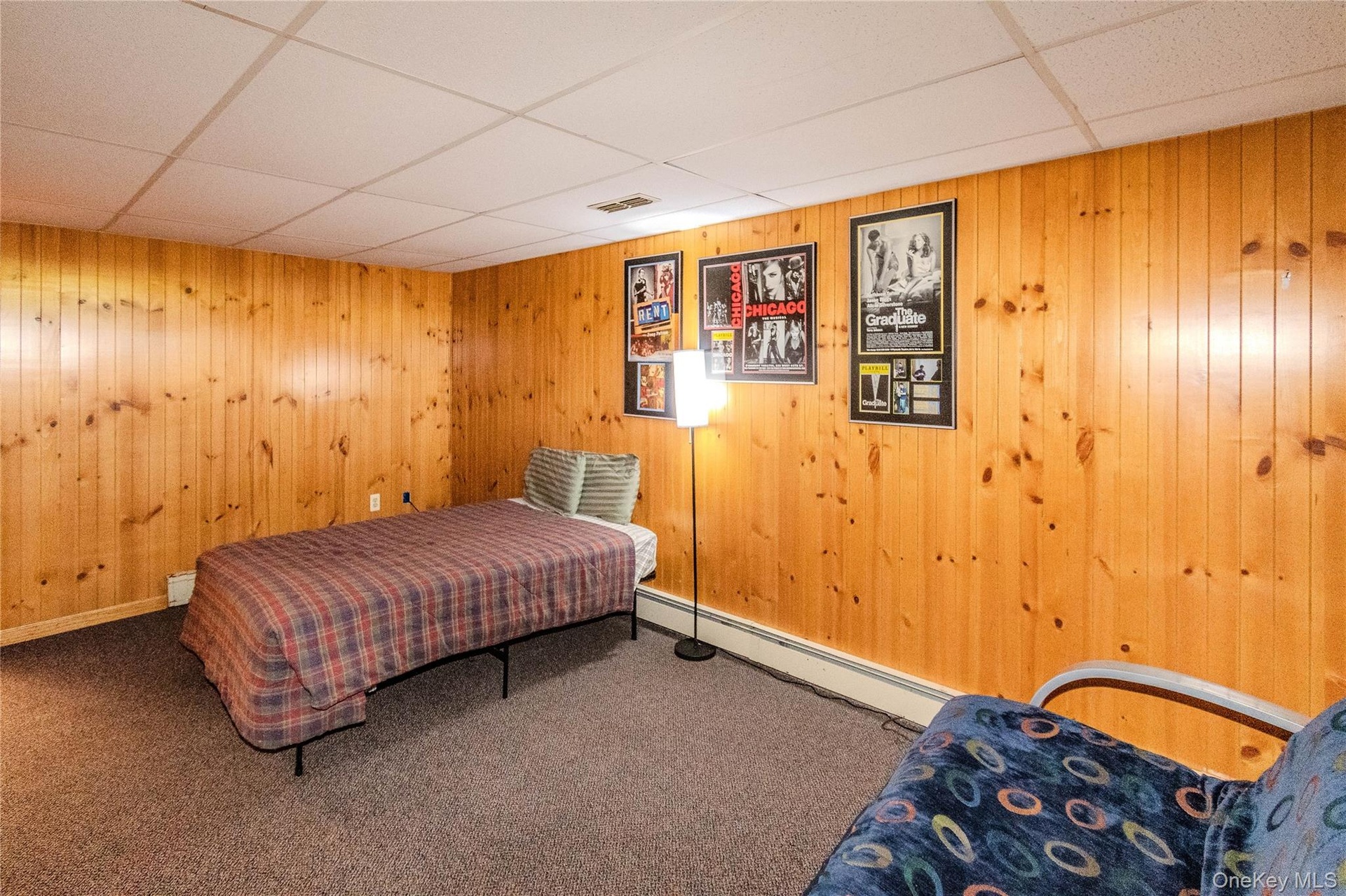 Wood paneling walls complement a drop ceiling with integrated lighting