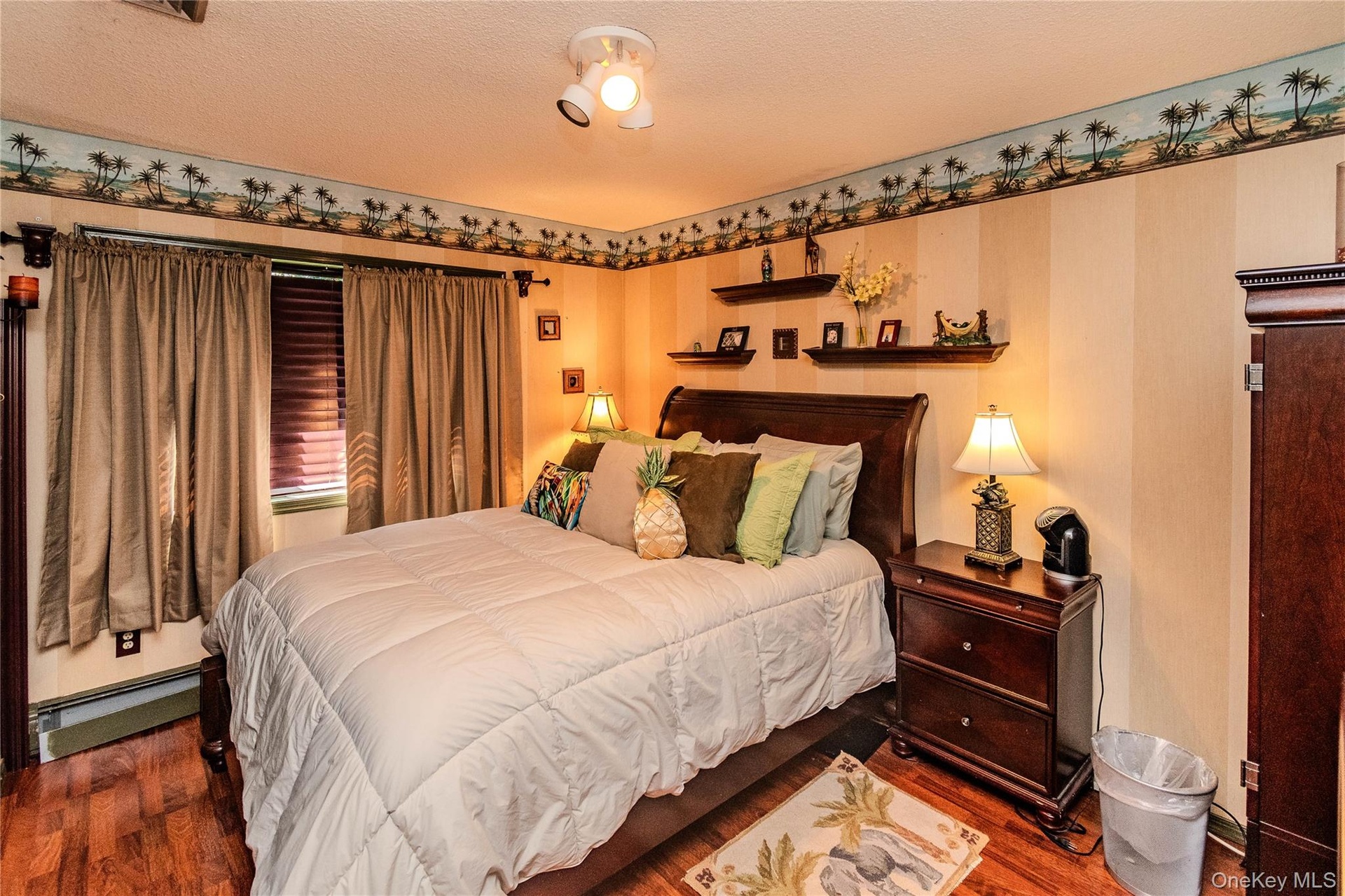 Wood-finish flooring with a decorative border and track lighting