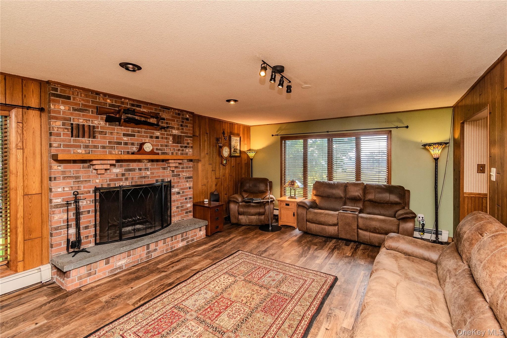 Brick fireplace with a stone hearth and wood mantel