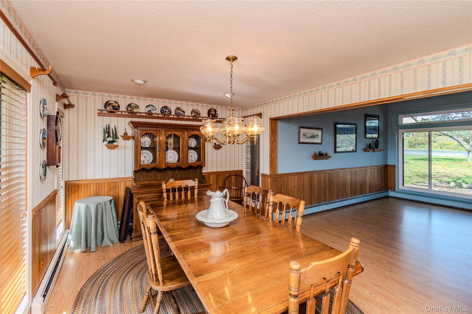 Wood-finish flooring throughout, featuring a chandelier light fixture