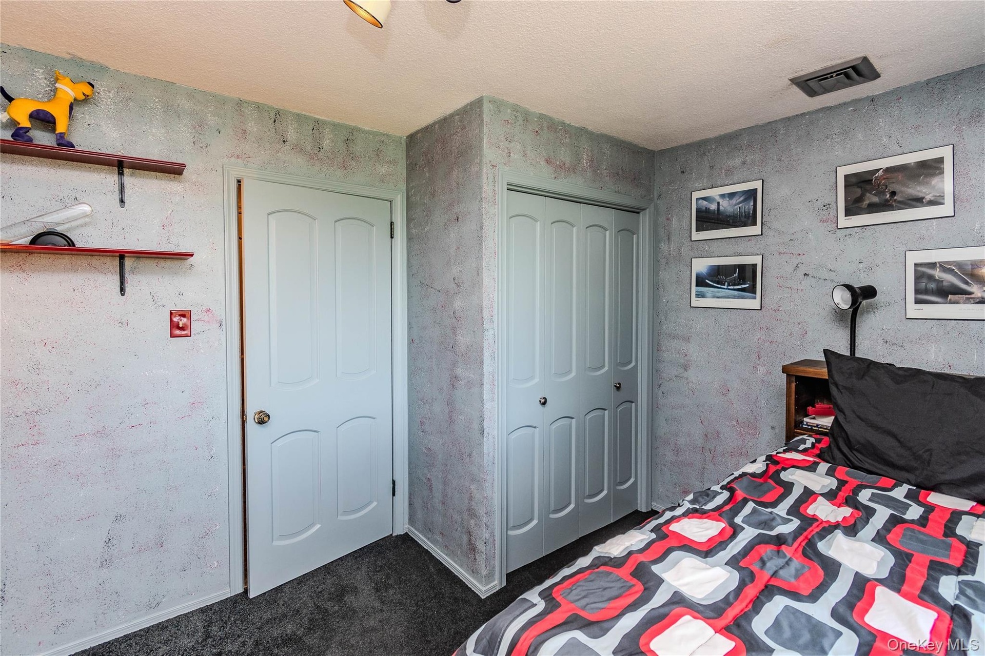 Recessed lighting, light-colored ceiling, textured wall finish, paneled interior door, and bi-fold closet doors