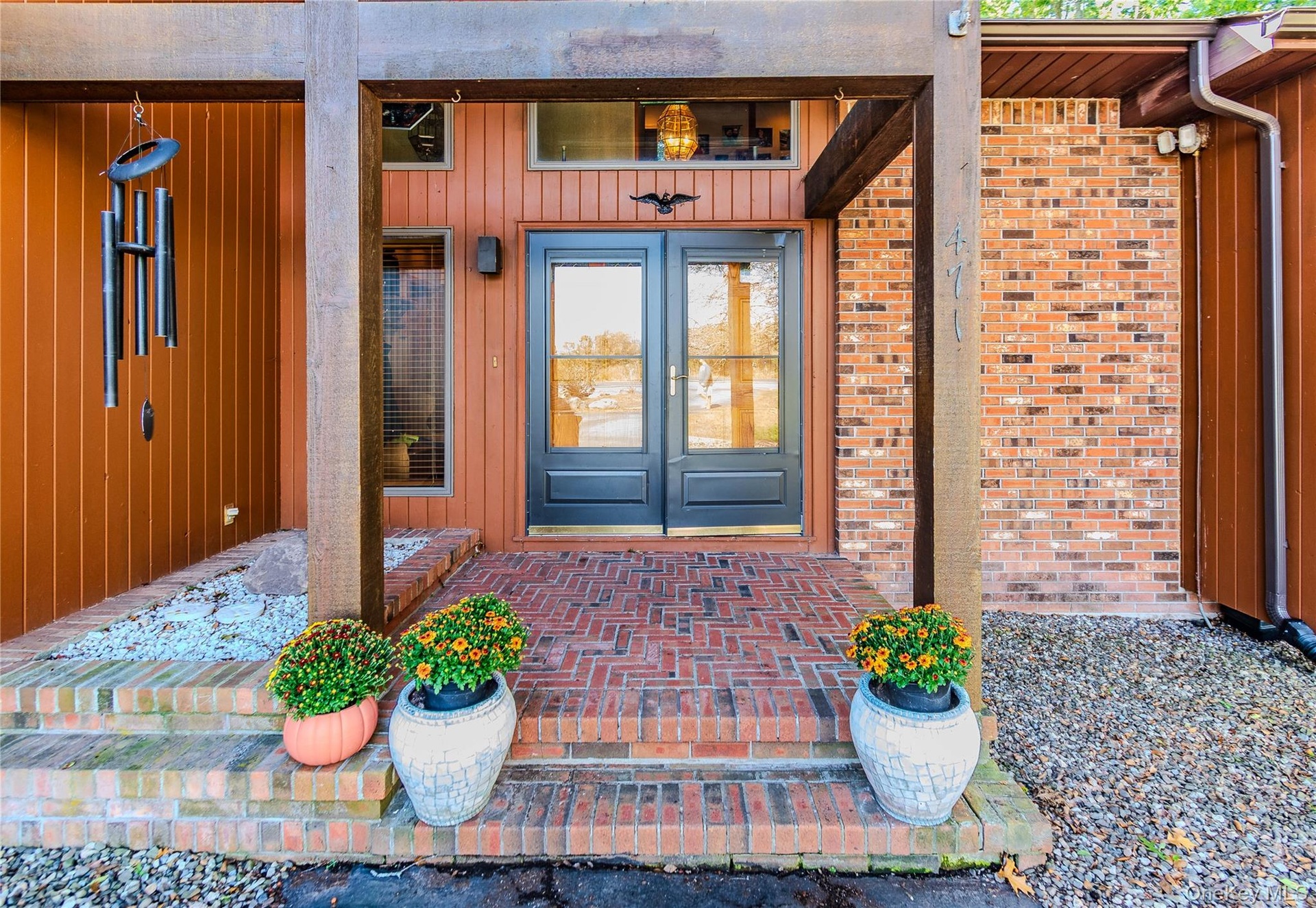 Brick and vertical wood siding exterior with a covered entry
