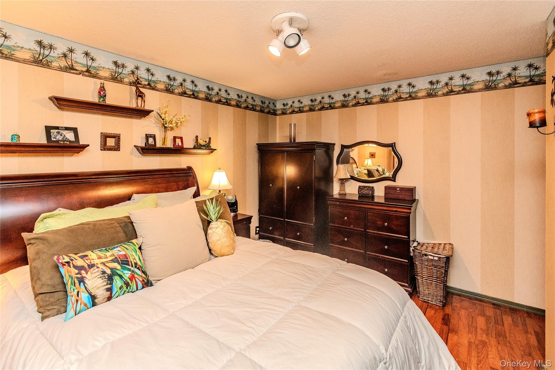 Wood-finish flooring, built-in wall shelves, and a decorative wall border
