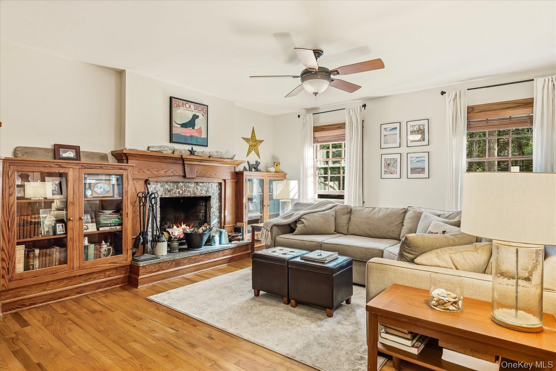 Den with wood burning fireplace, Hardwood flooring