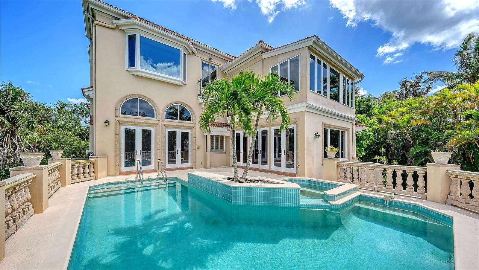 French doors open directly to the pool terrace, seamlessly connecting the home with its private outdoor setting.