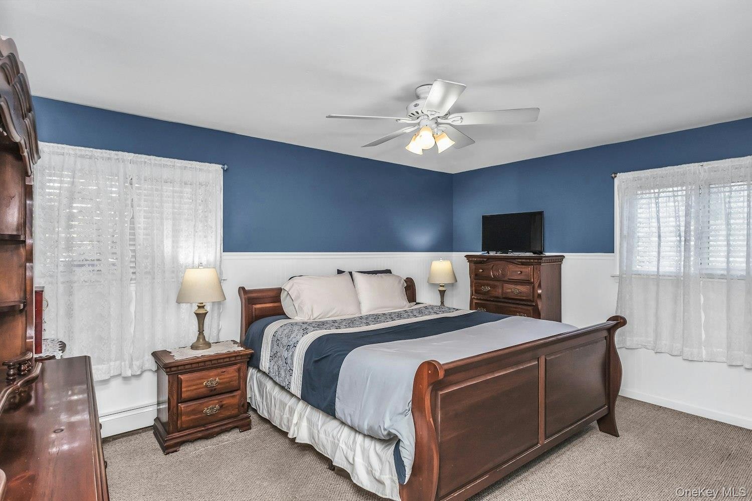 Primary Bedroom With Hard Wood Floors Under Carpet and Double Closet