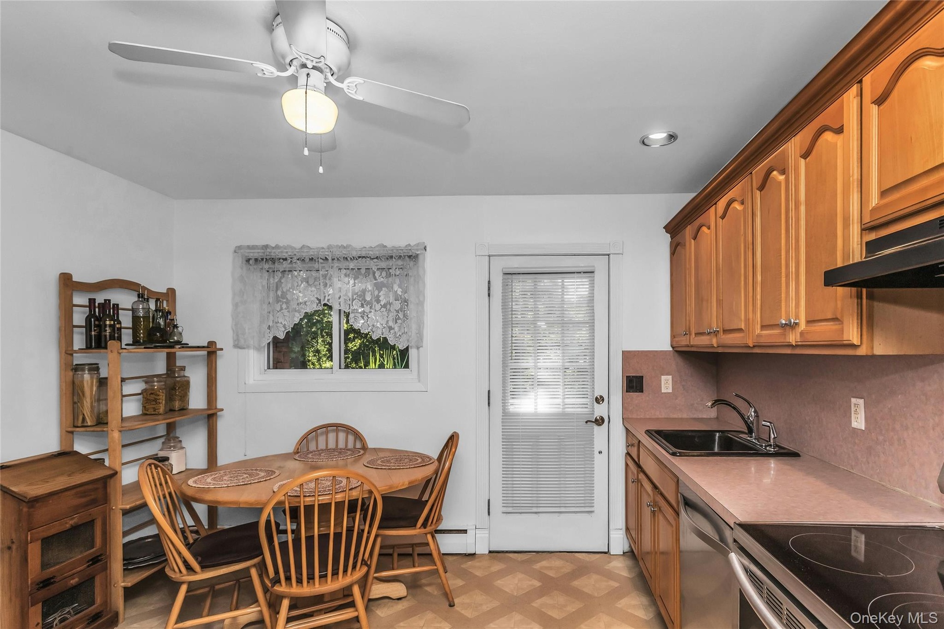Kitchen With Door Leading To Wood Deck