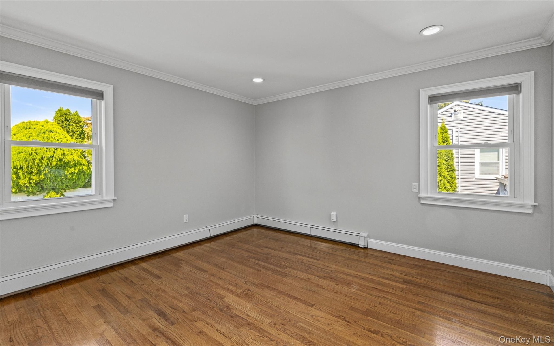 Hardwood flooring, crown molding, recessed lighting, and dual windows