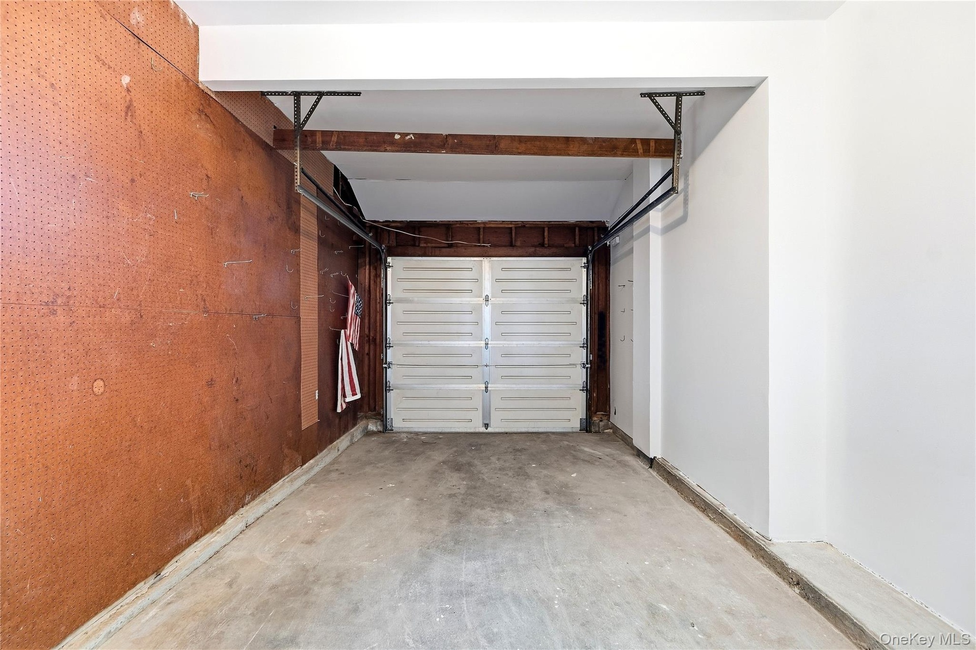 Single car space with concrete flooring