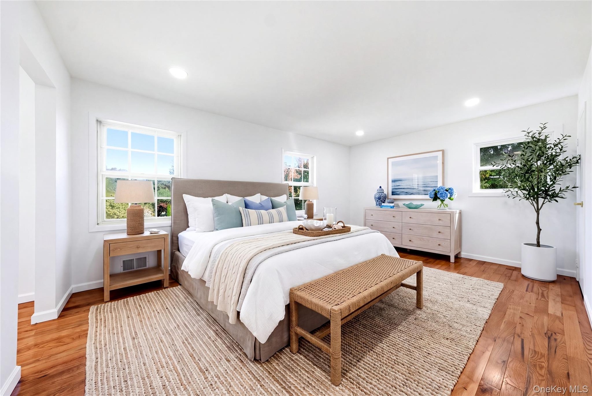 Virtually staged. Hardwood flooring, multiple windows, recessed lighting, and a neutral color palette