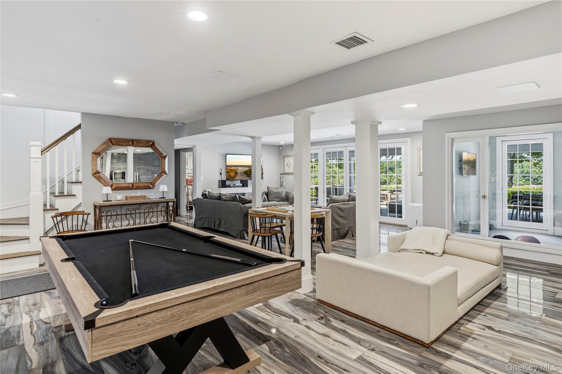 Recreational space featuring a wine room and glass French doors to outdoor covered patio.