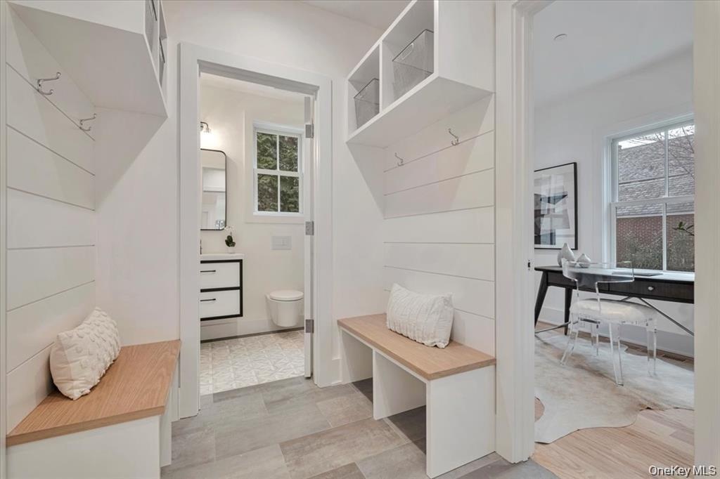 Sample of mudroom with benches and cubbies linking the attached garage to the home