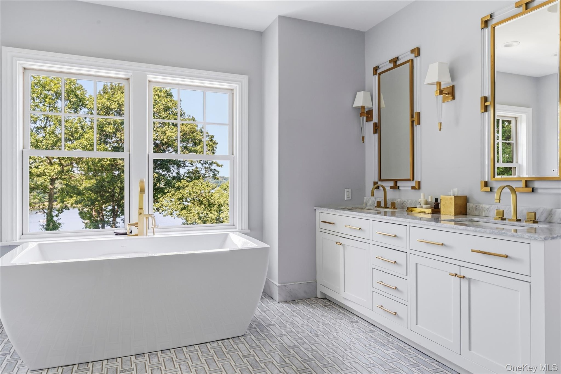 Freestanding soaking tub with a  dual vanity and waterviews