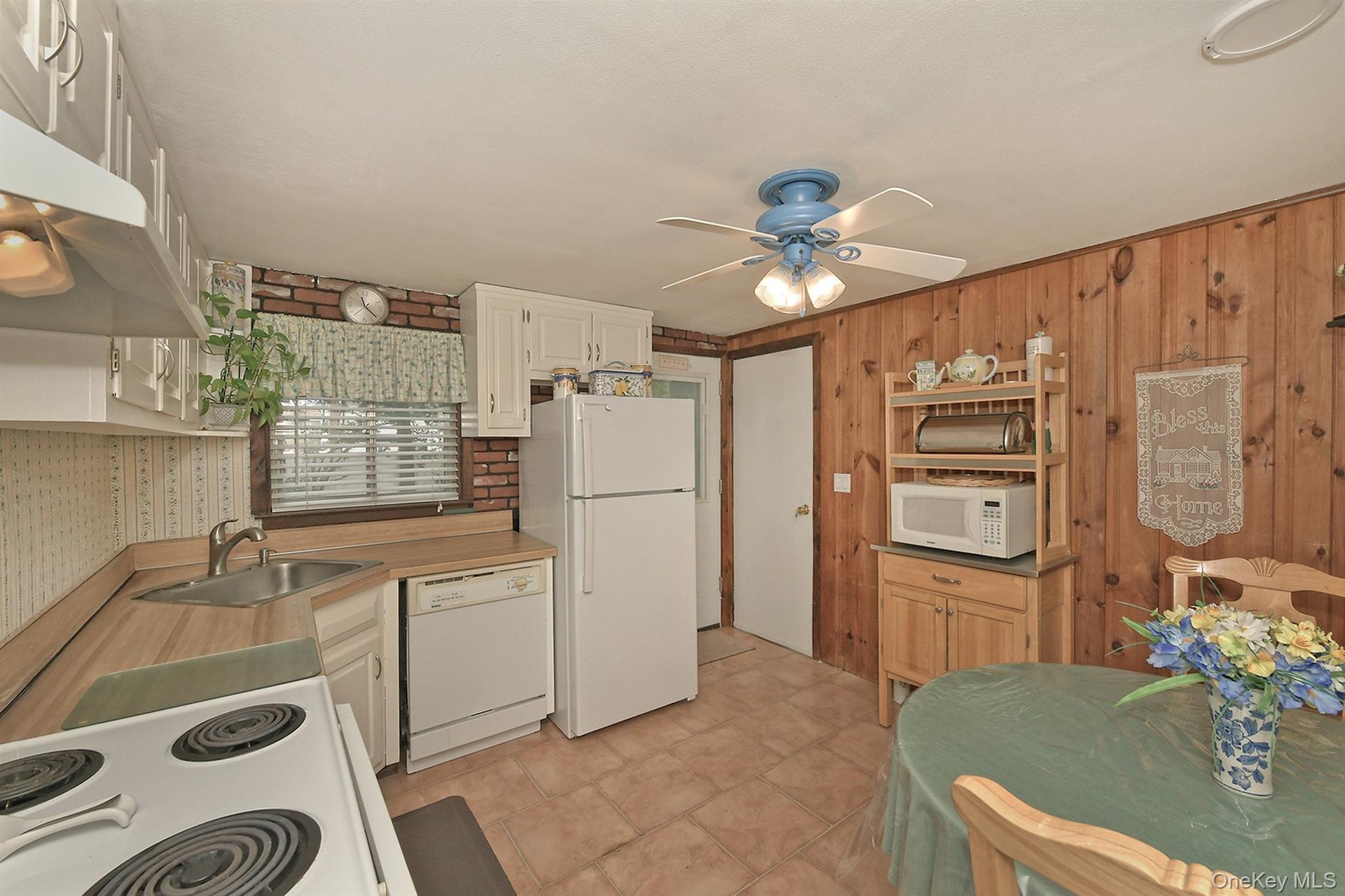 Lower Level Eat in Kitchen, Electric Stove, Dishwasher, Refigerator Ceiling Fan. Tiled Floor with access to Laundry Room & Sep. Door to Yard.