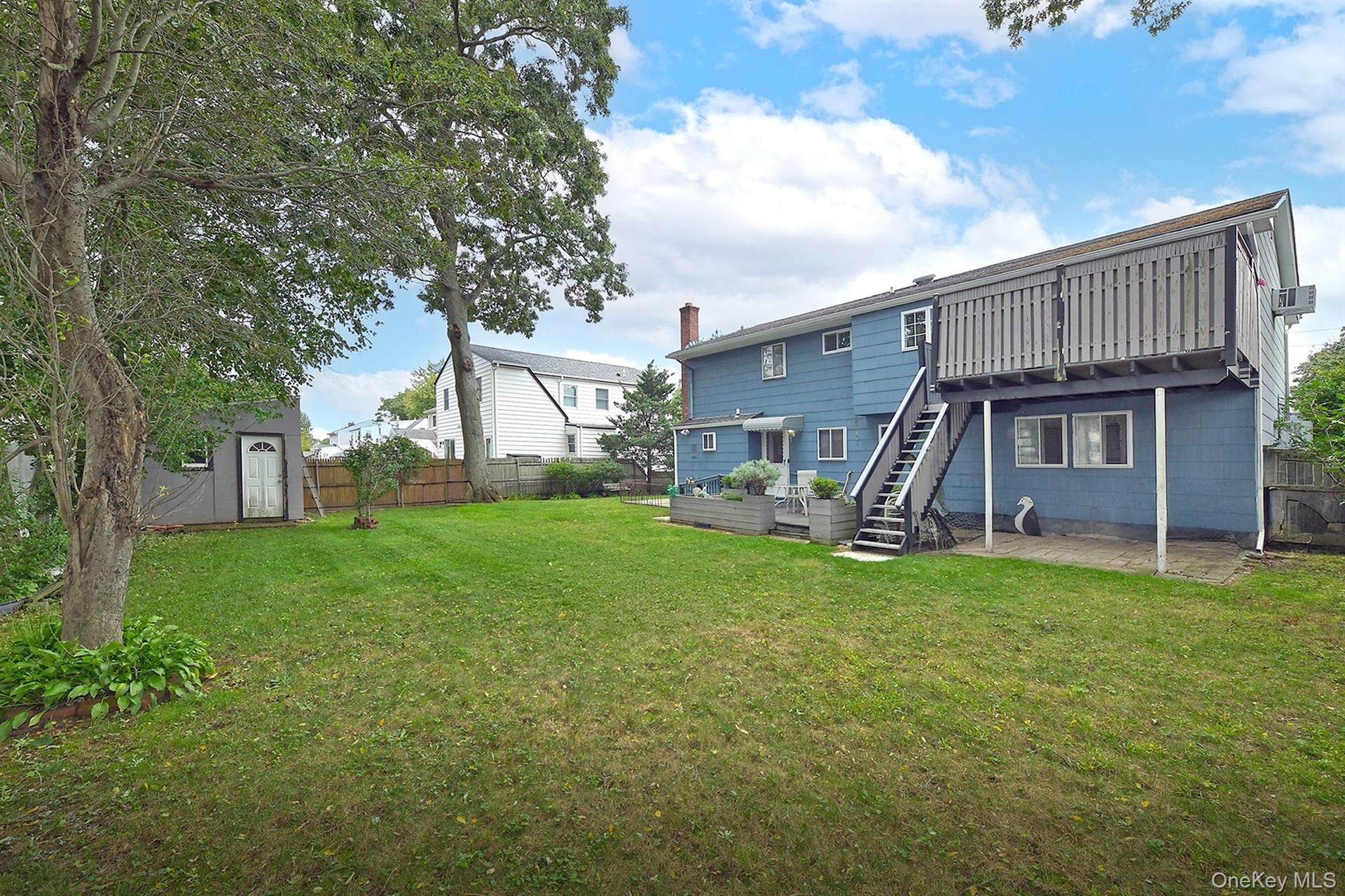 Fenced Rear Yard with Trex Decks, Patios & large Shed