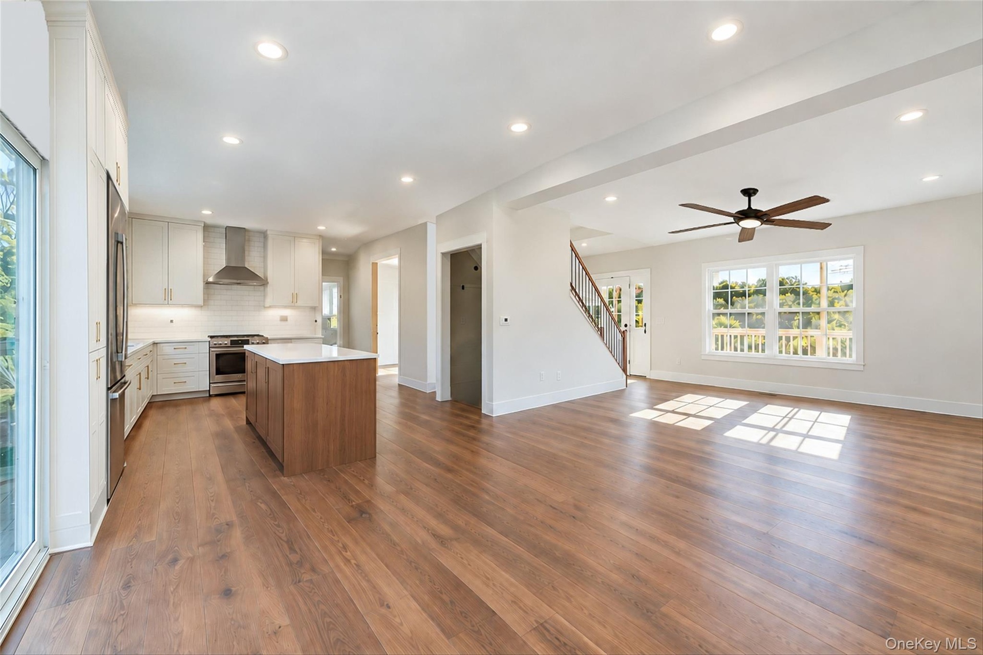 Virtually Staged - Kitchen. First Floor will have hardwoods. Kitchen cabinets in white/dove color. Island will be similar to the hardwoods.
