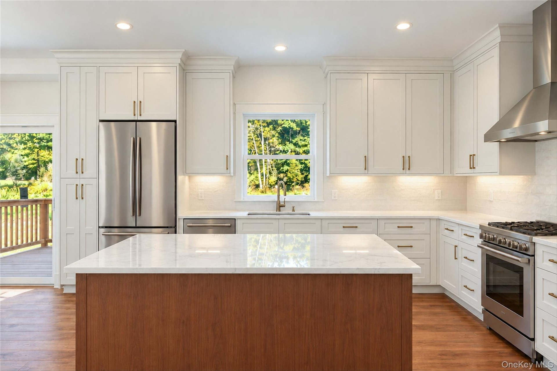 Virtually Staged - Kitchen. First Floor will have hardwoods. Kitchen cabinets in white/dove color. Island will be similar to the hardwoods.