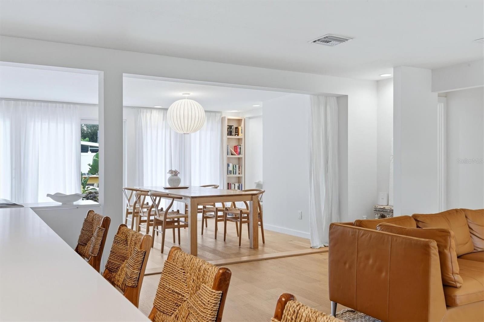The area then flows from this point through to the dining room, highlighted by a built-in bookcase and accented by a magnificent Noguchi-Style Shoji P