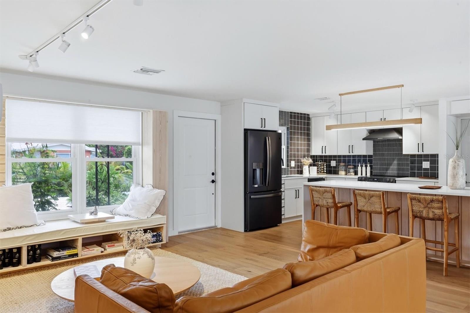 Step into the home through the front entrance and to the left see a brand new open kitchen with a ceramic and stone backsplash, quartz countertops, al