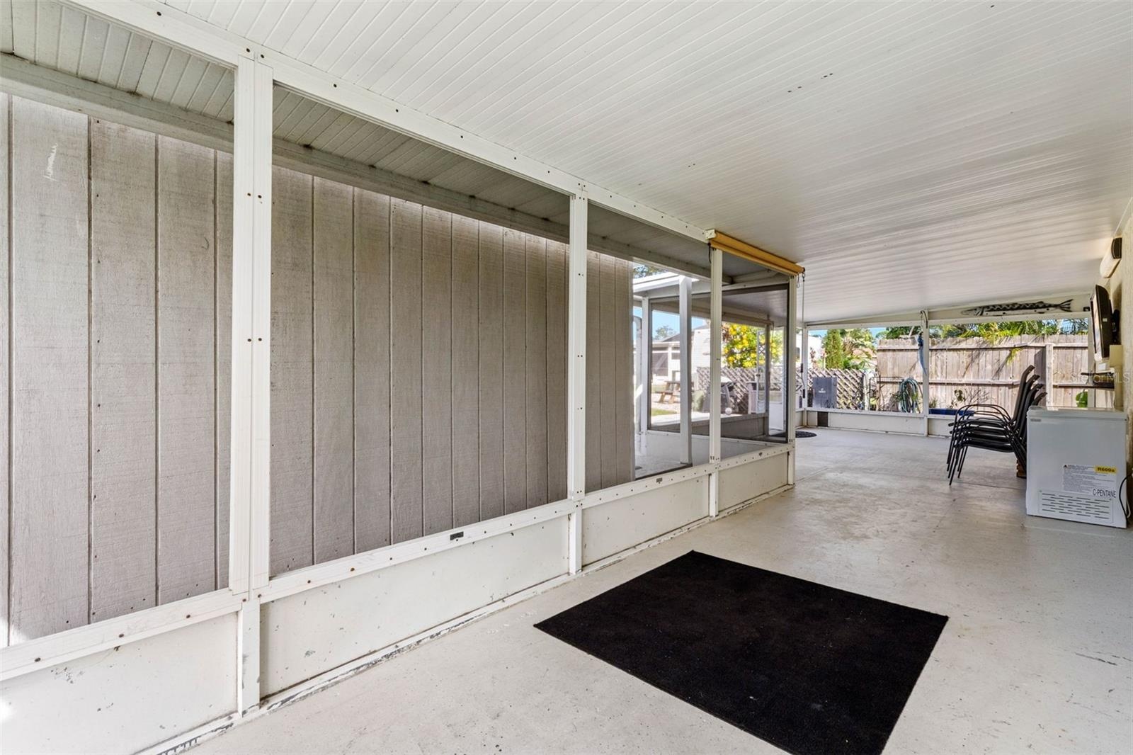 The spacious screened lanai offers a long stretch of covered outdoor living space with plenty of room for dining, lounging, and gathering while stayin