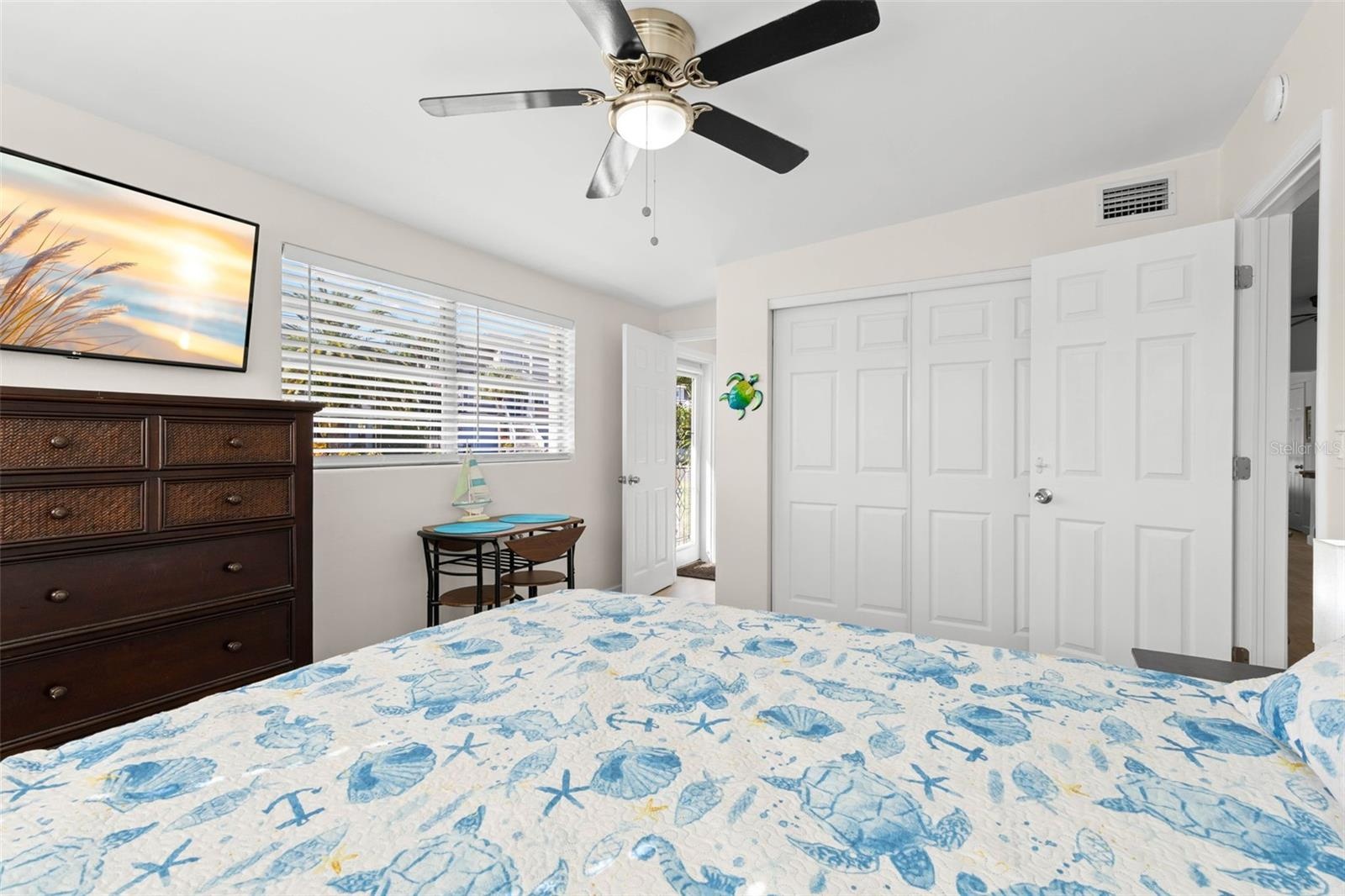 The third bedroom includes a wide closet, large window, ceiling fan, neutral finishes, and luxury vinyl plank flooring (2025), with plenty of room for