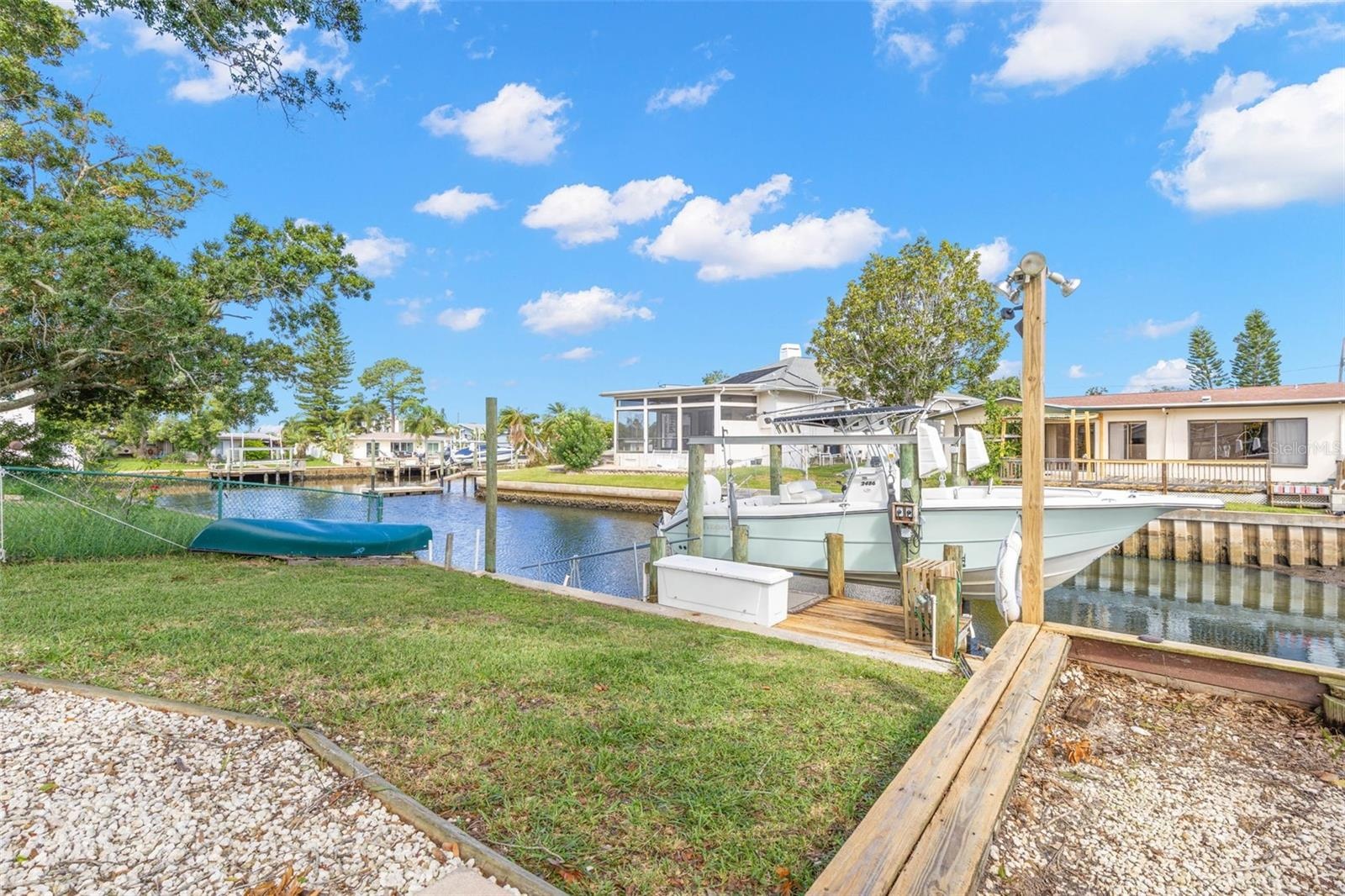 Boating starts in your own backyard, with canal frontage, private dockage, a boat lift, and direct access toward the Gulf—all just steps from the lawn