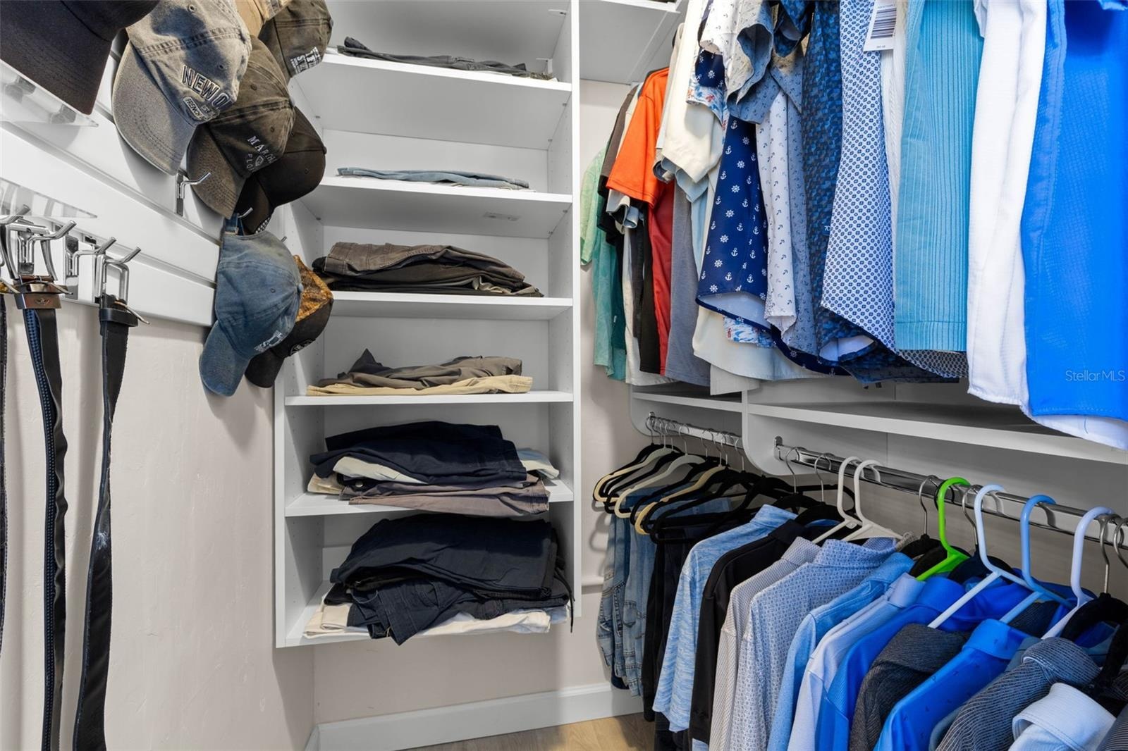 A well-organized walk-in closet in the primary suite offers built-in shelving, double hanging space, and plenty of room to keep clothing and accessori