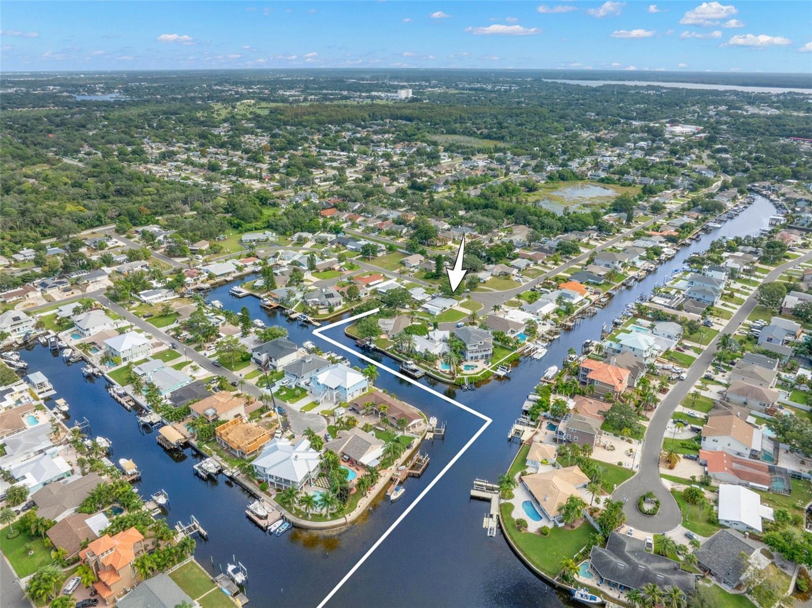 A dramatic aerial view captures Baywood Village’s interconnected canal system and the boating lifestyle that defines the neighborhood, with waterfront