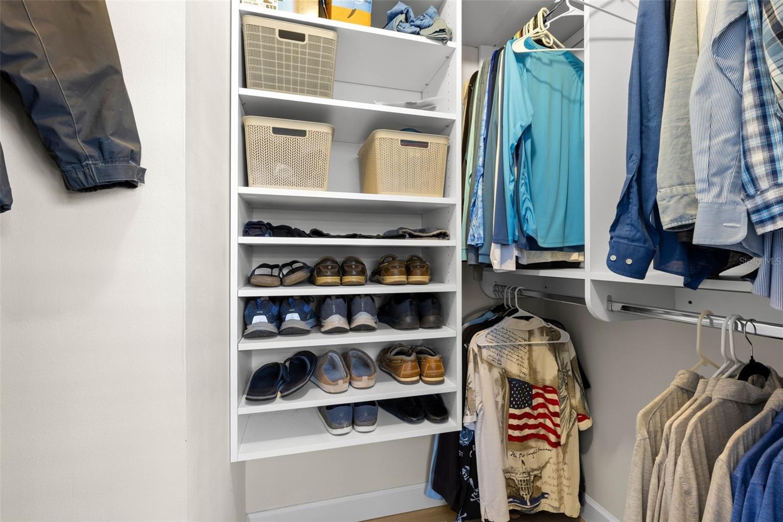 A well-organized walk-in closet in the primary suite offers built-in shelving, double hanging space, and plenty of room to keep clothing and accessori