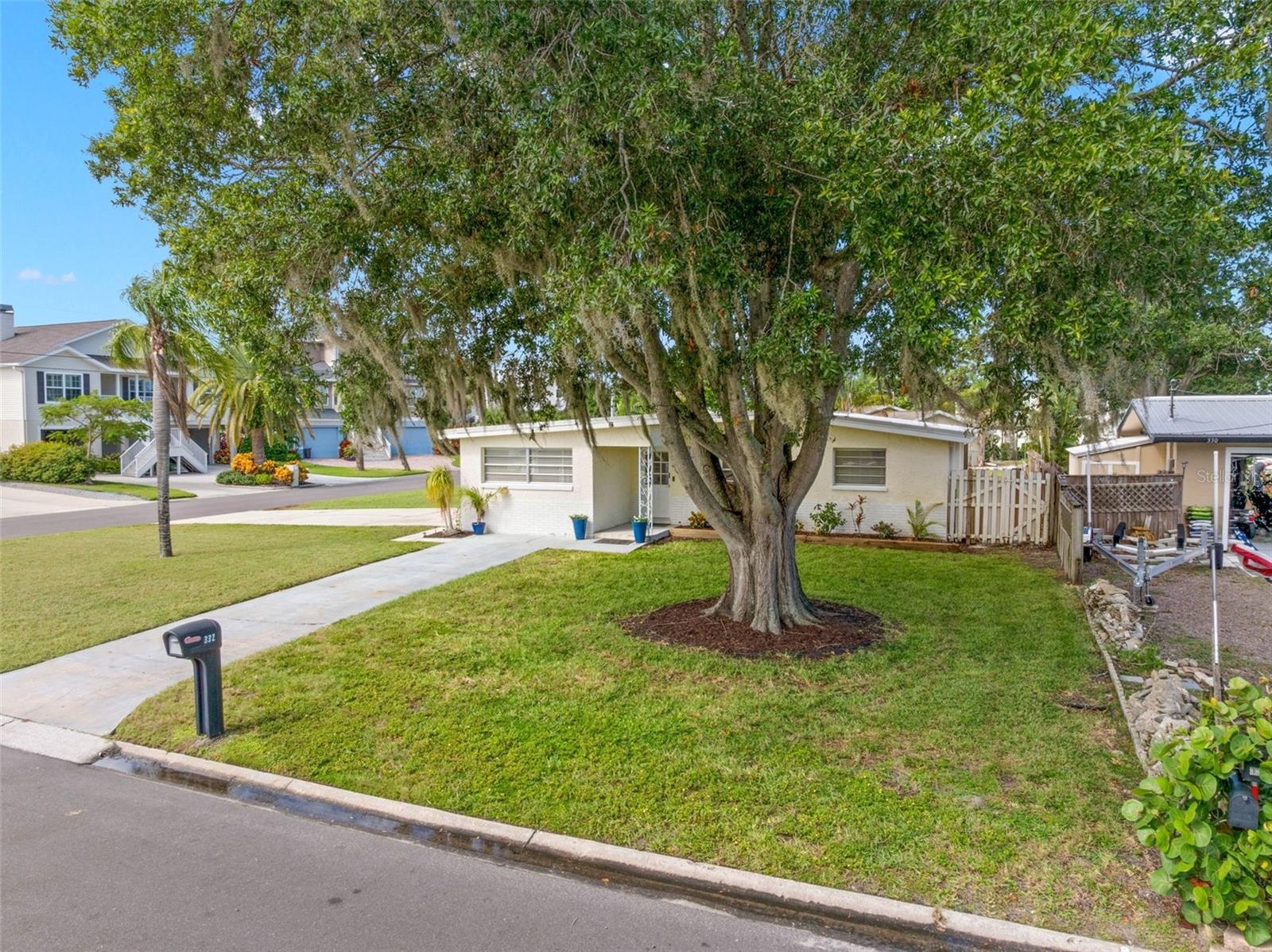 magnificent mature oak anchors the broad front lawn, while the home’s corner setting creates a wonderful sense of space and separation from neighborin