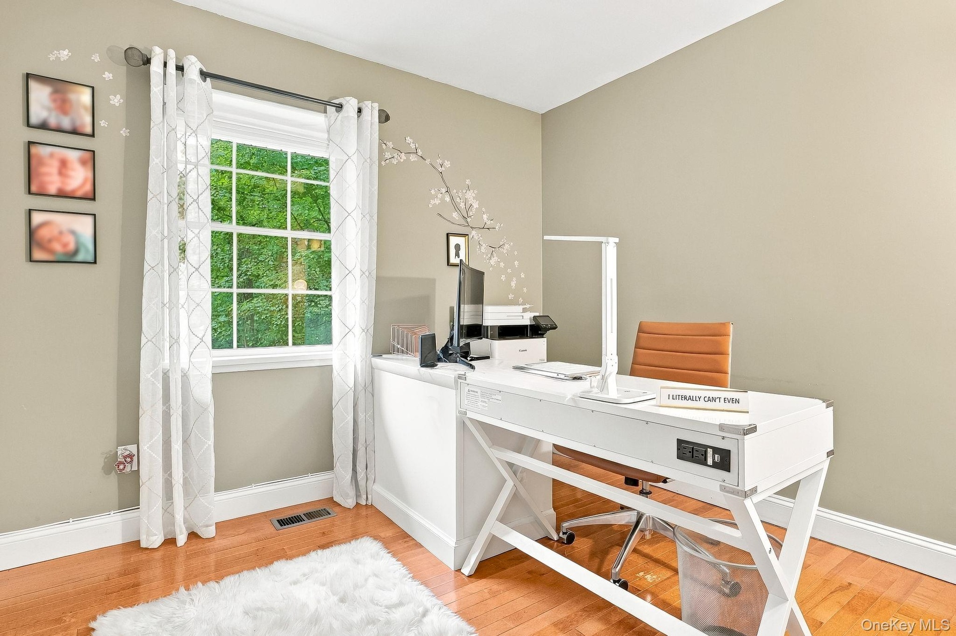 Hardwood flooring, neutral wall paint, white trim, and a multi-pane window