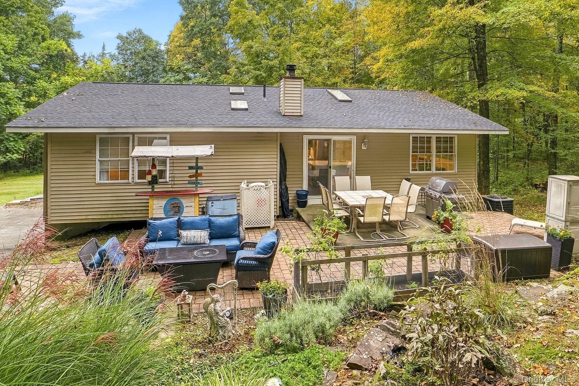Exterior with horizontal siding, a dark shingle new roof, and patio