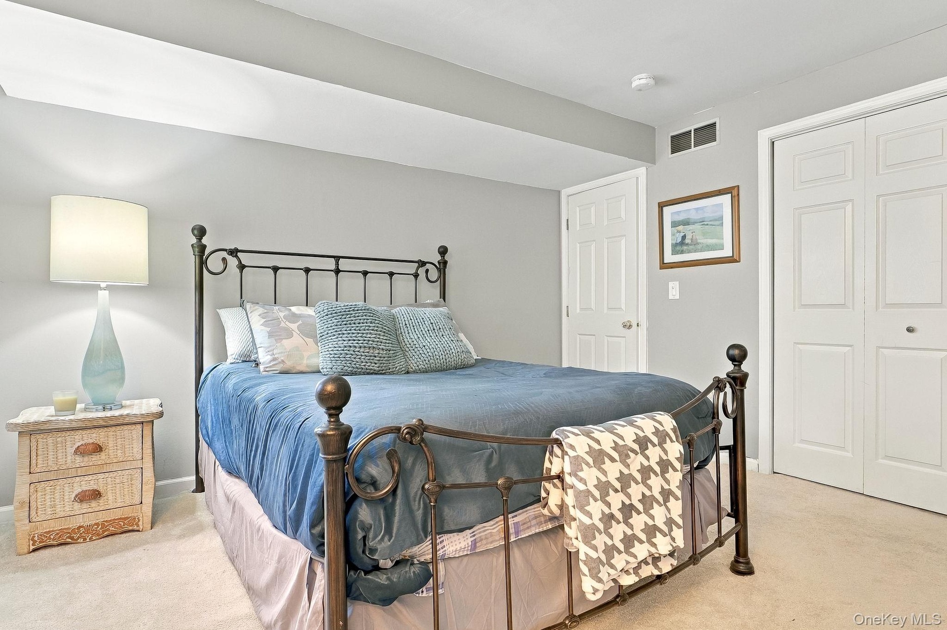 Plush carpeting, neutral wall color, and a white six-panel door