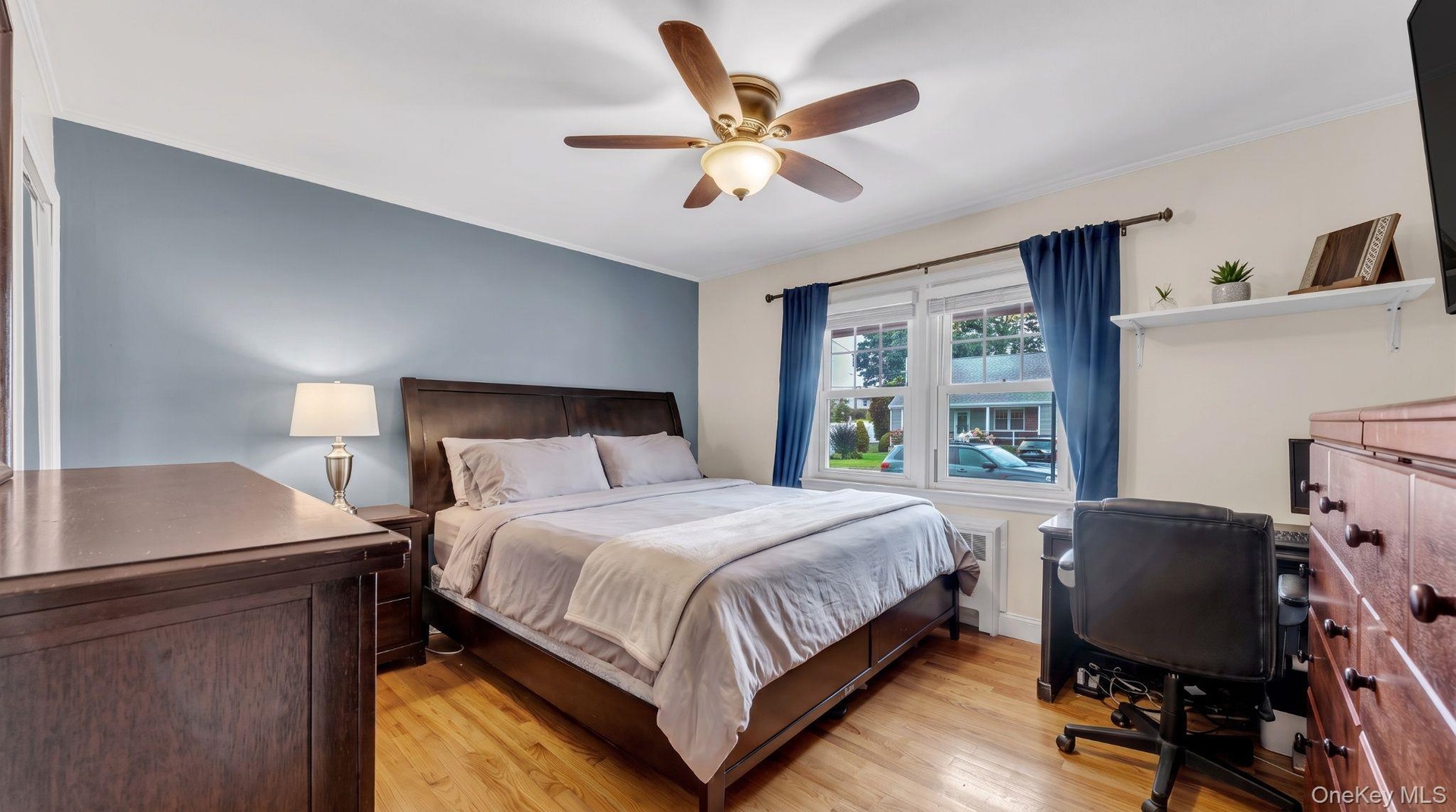 Hardwood flooring, ceiling fan with light fixture, double windows.