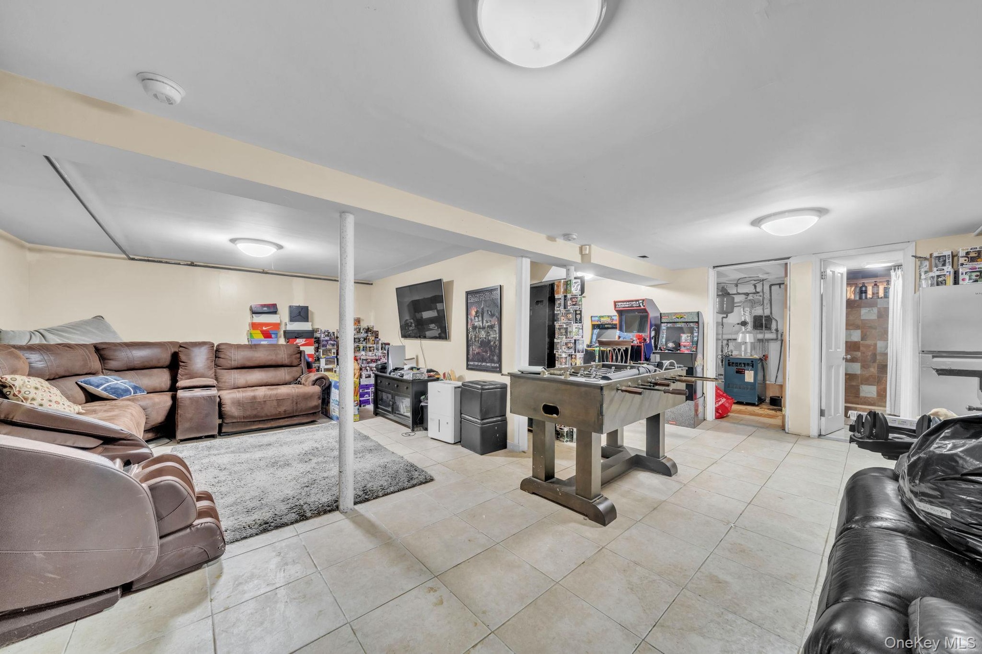 Expansive basement featuring tile flooring and recessed lighting