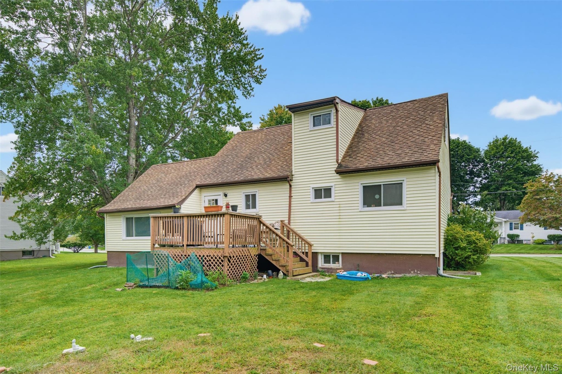 Wood deck with railing, stairs, and lattice skirting