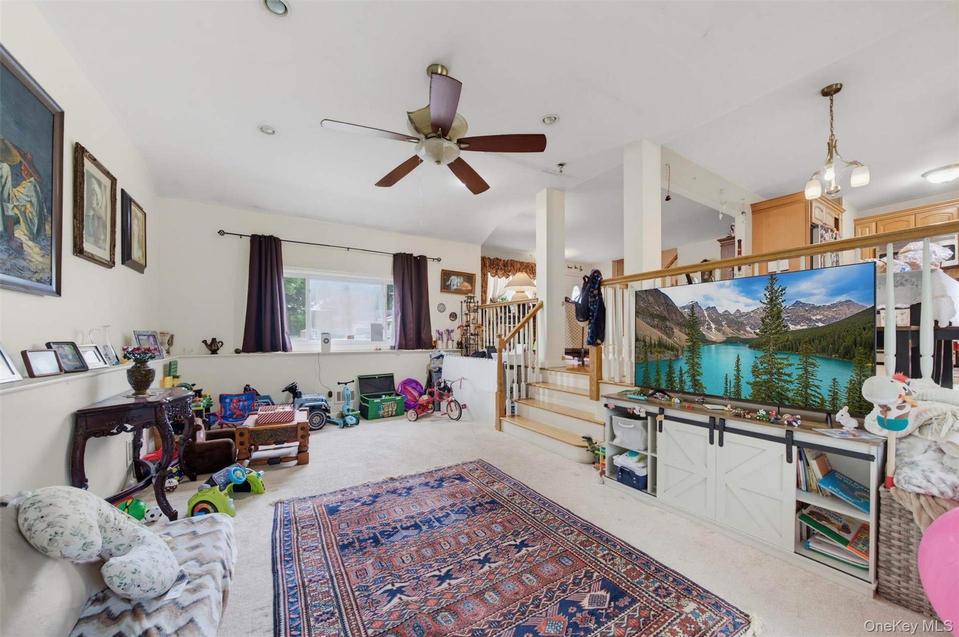 Recessed lighting, ceiling fan, and window with dark drapery