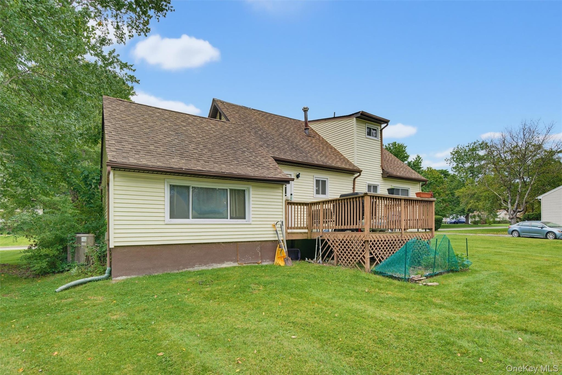 Rear deck with wood railing, providing outdoor living space
