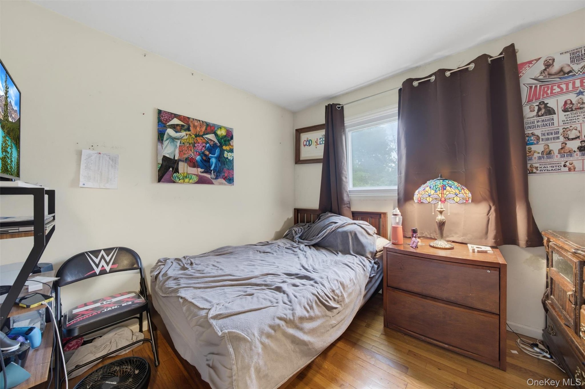 Hardwood-finish flooring, a window with drapery, and a built-in wall shelf